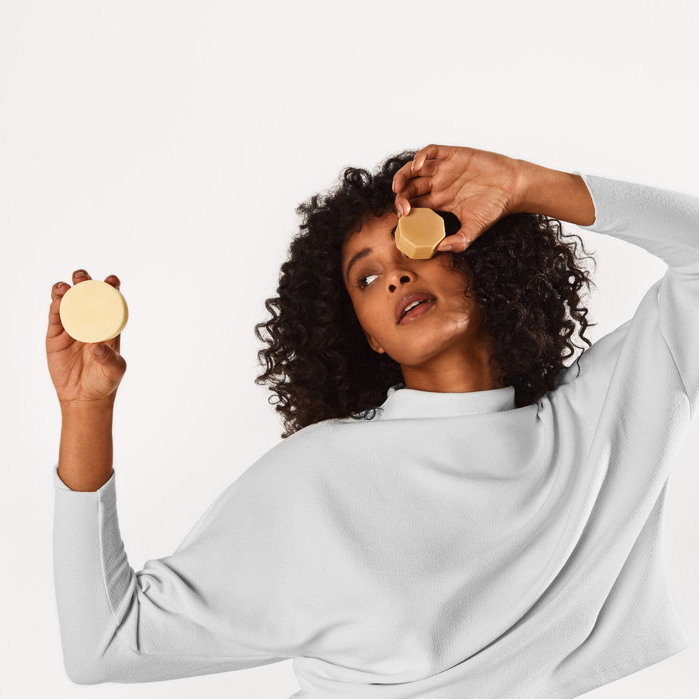 Why & How To Use Hair Masks for Curly Hair Girl holding the Curl Definer Conditioner Bar and Curl Defining Hair Mask