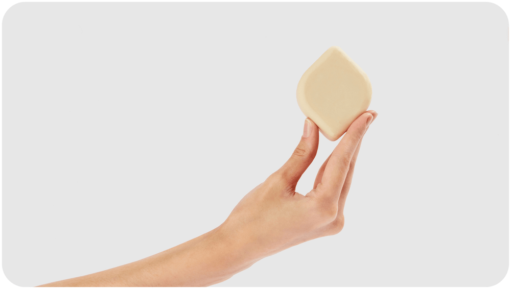 6 Myths and Facts About Intimate Washes Woman’s hand holding Bars Over Bottles intimate wash