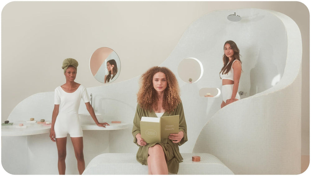 Meet the Vegan Shampoo and Conditioner Bars That Are Here To Save Your Hair – And the Planet Vegan shampoo and conditioner bars and two women in white behind a woman in green robe holding a book