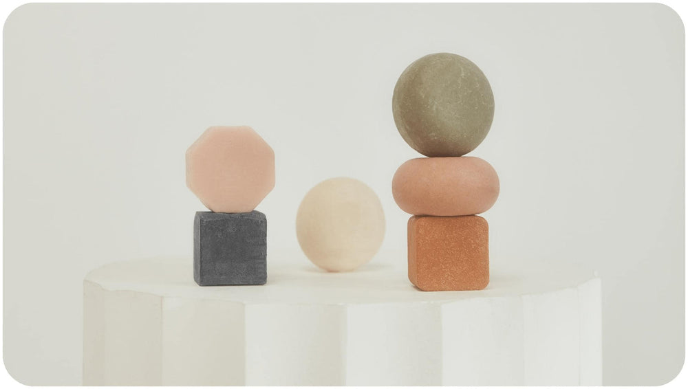 Bars Over Bottles beauty bars on a white round stone stool