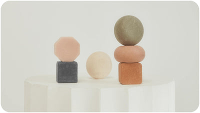 Bars Over Bottles beauty bars on a white round stone stool